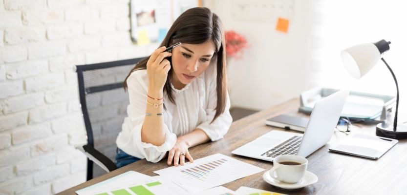 Retail buyer reviewing pitch materials at their desk