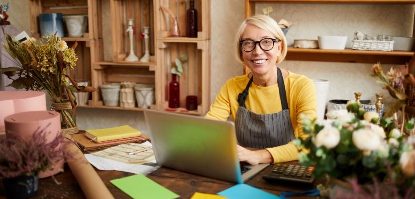 A product business owner reviewing their retail strategy on a laptop.
