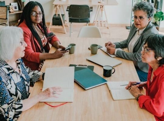 Small business owner pitching a product to a retail buyer across a table