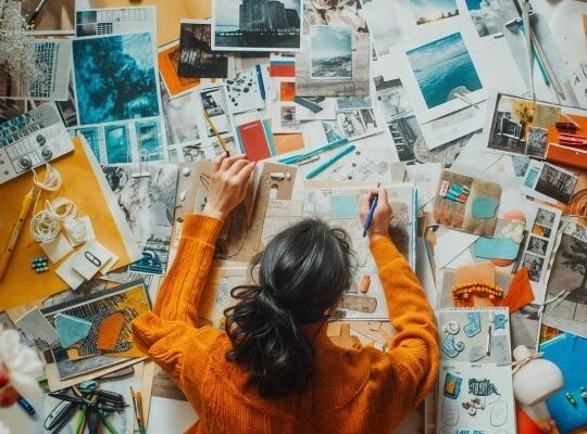 Overhead view of a crowded desk with a plate full of marketing items symbolising an overloaded to-do list.