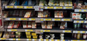 Retail food-to-go fixture showing a variety of sandwiches and snacks across UK supermarkets.