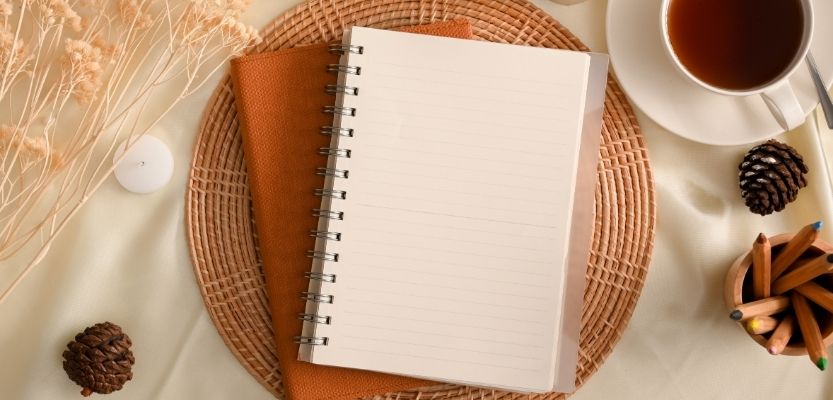 notepad and tea, symbolising focus and a fresh marketing start