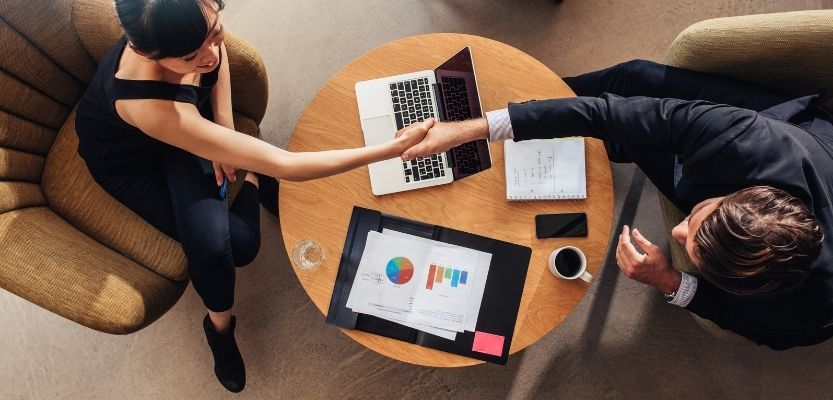 Supplier and retail buyer discussing a category presentation together.