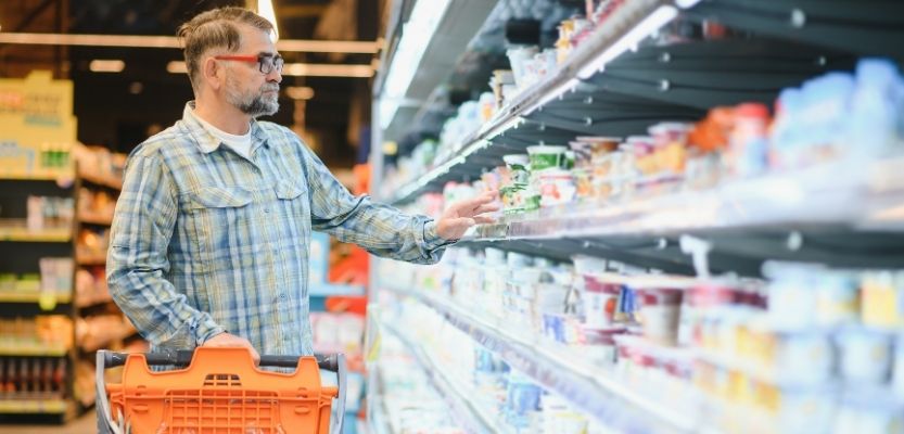 Shopper choosing trusted brand from store shelf.