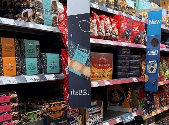 Retail shelves filled with Christmas food products highlighting brand visibility