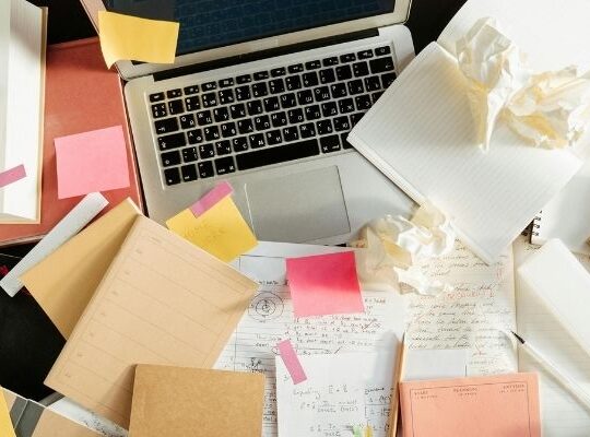 Notebook and tea on desk symbolising marketing planning and direction