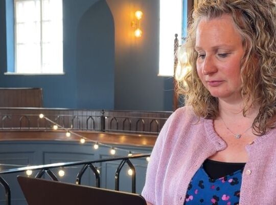 Marketing consultant reviewing a small business's marketing strategy at a desk.
